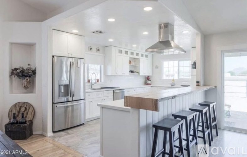 A modern kitchen with stainless steel appliances and white cabinets.