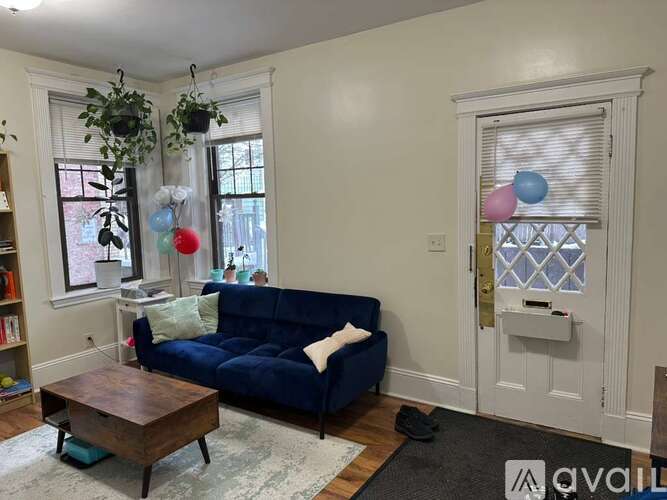 A living room with a blue couch and a coffee table.