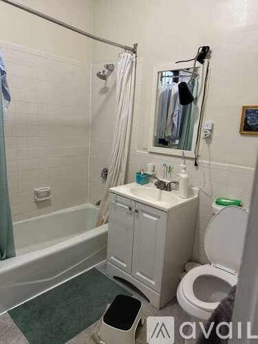 A bathroom with a toilet, sink, and bathtub.