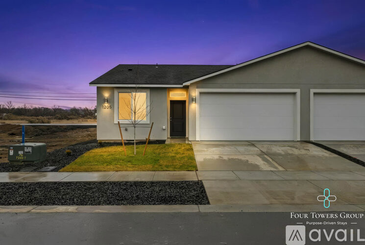 A house with a garage is for sale by the Four Towers Group.