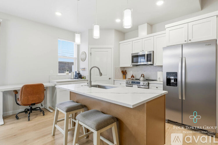 A kitchen with a white countertop and stainless steel appliances.