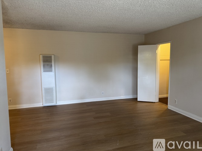 A room with wooden floors and a white door.