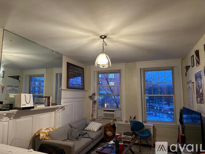A living room with a grey couch and a white ceiling.