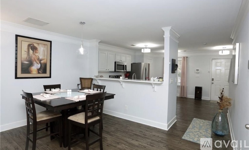 A dining room with a table set for four.