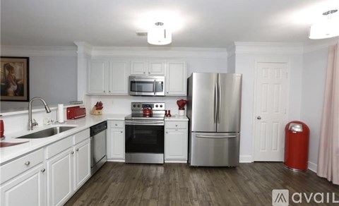 A kitchen with white cabinets and stainless steel appliances.