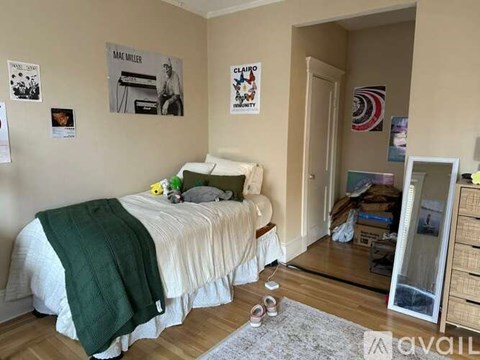A bedroom with a bed, a dresser, and pictures on the wall.
