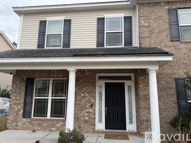 A house with a black front door and white trim.