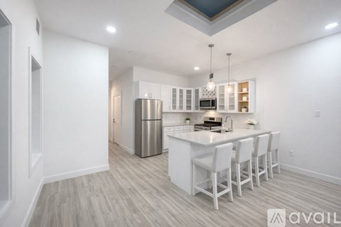 A modern kitchen with white cabinets and a large island.