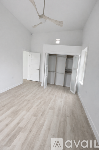 A white toilet is next to a walk-in shower.