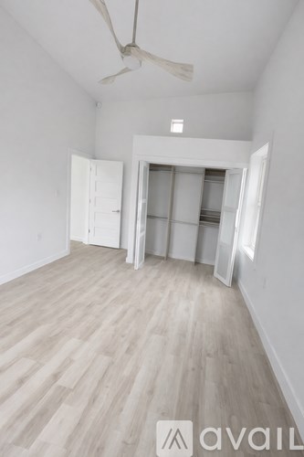 A white toilet is next to a walk-in shower.