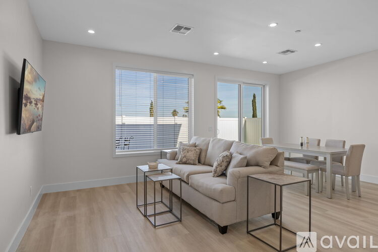A living room with a couch, a coffee table, and a painting on the wall.