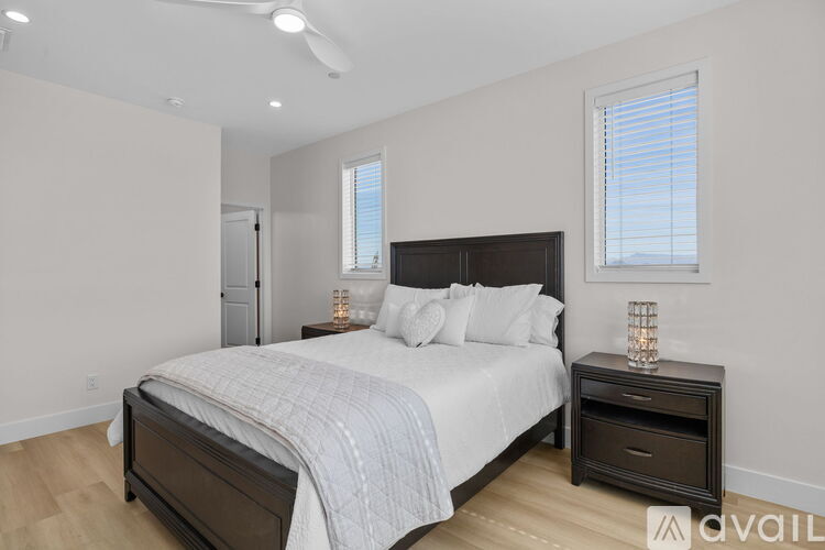 A bedroom with a large bed and a nightstand.