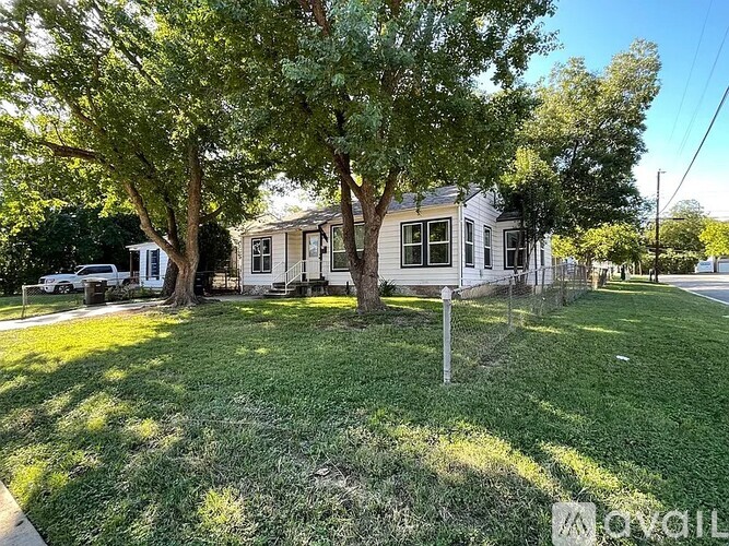 A house with a tree in front of it.