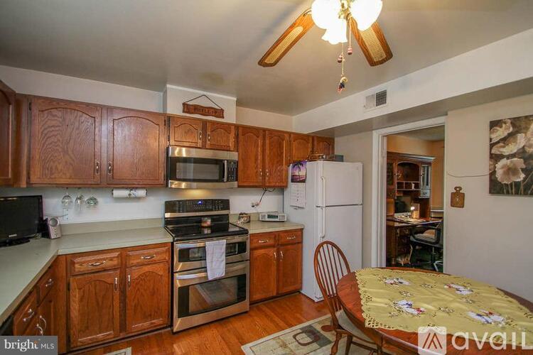 A kitchen with wooden cabinets and a stove top oven.