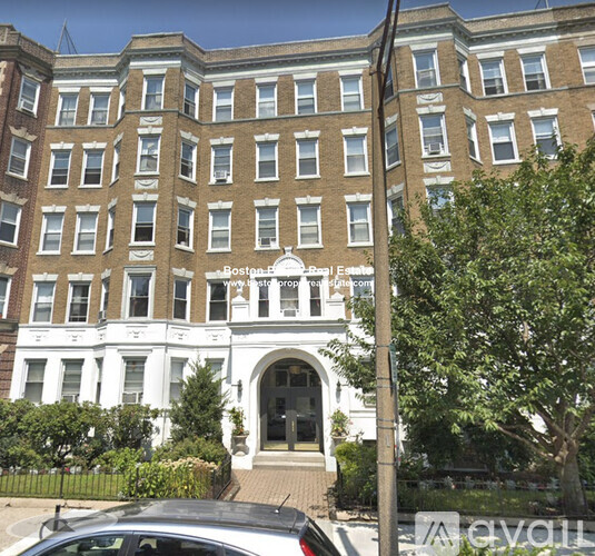A building with a white entrance and a sign that says Boston.