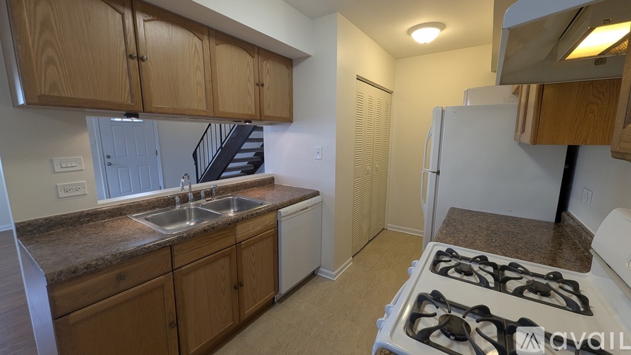 A kitchen with a stove top oven and a sink.