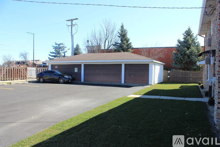 A car is parked in front of a garage with a sign that says "available".