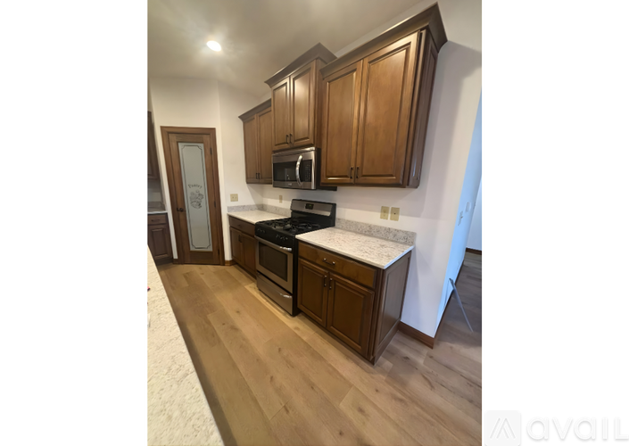 A kitchen with wooden cabinets and a white countertop.
