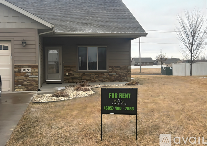 A house with a for rent sign in front of it.