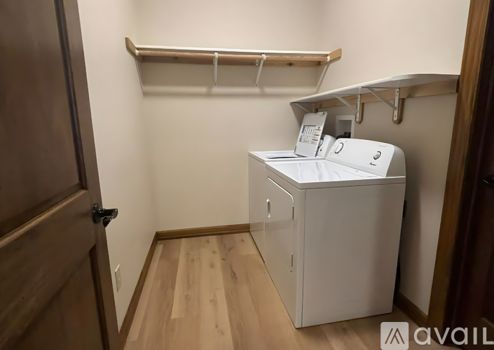 A small laundry room with a washer and dryer.