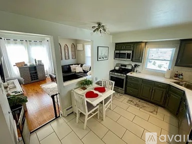 A kitchen with a table and chairs in the middle of the room.