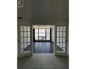 A hallway with a sign that says "REALTOR" on the wall.