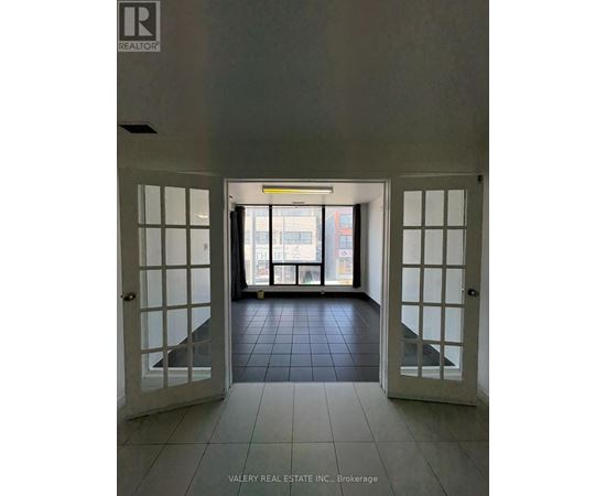 A hallway with a sign that says "REALTOR" on the wall.