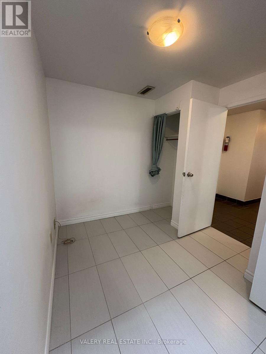 A white room with a doorway leading to another room.