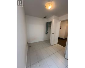 A white room with a doorway leading to another room.