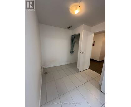 A white room with a doorway leading to another room.