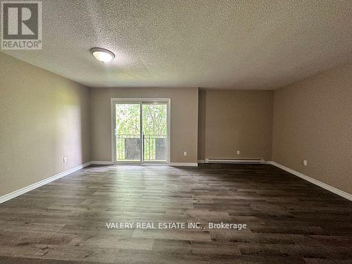A spacious room with a door leading to a balcony.