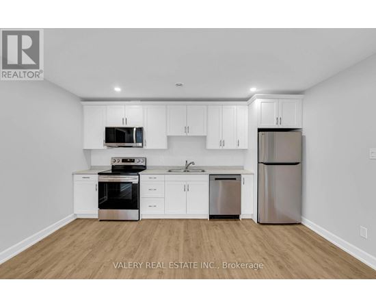 A kitchen with white cabinets and stainless steel appliances.