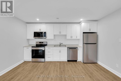 A kitchen with white cabinets and stainless steel appliances.