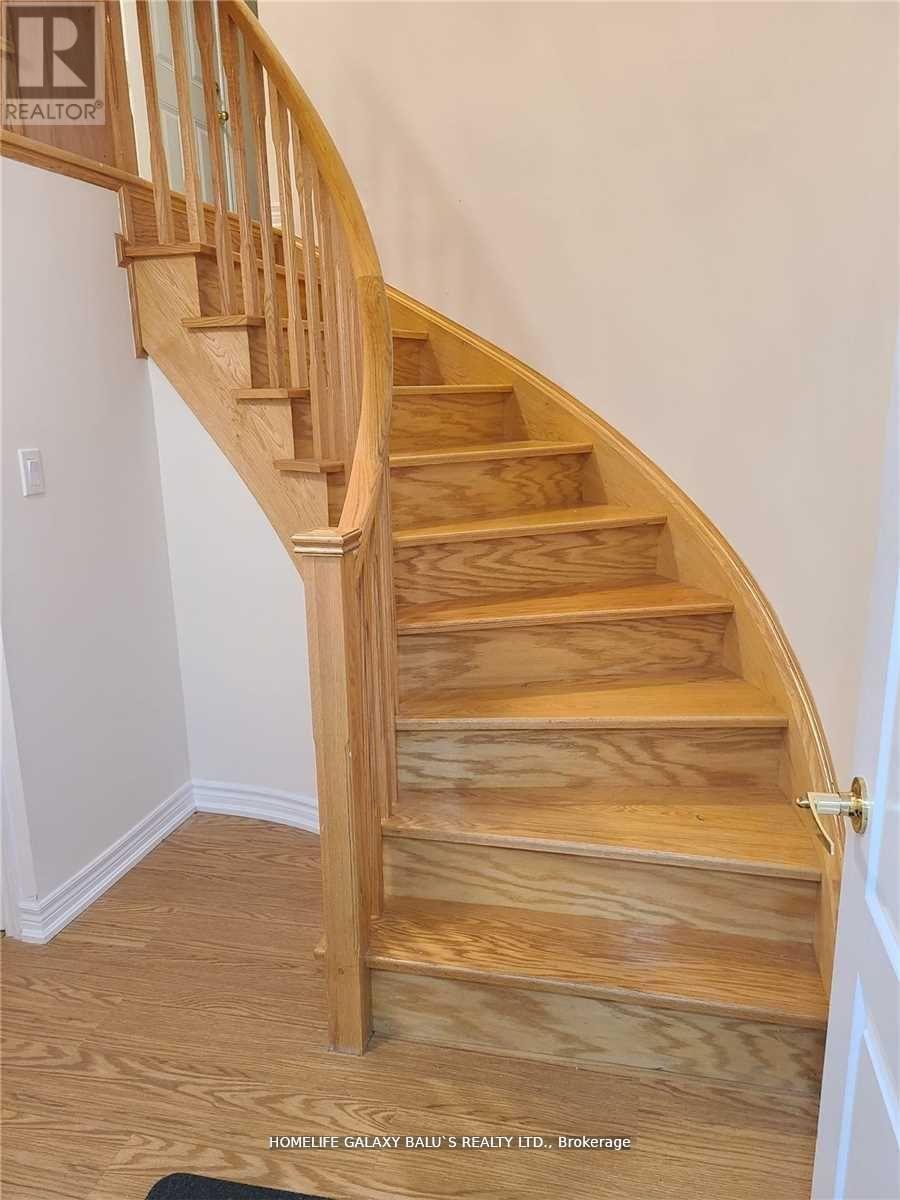 A wooden staircase with a handrail.