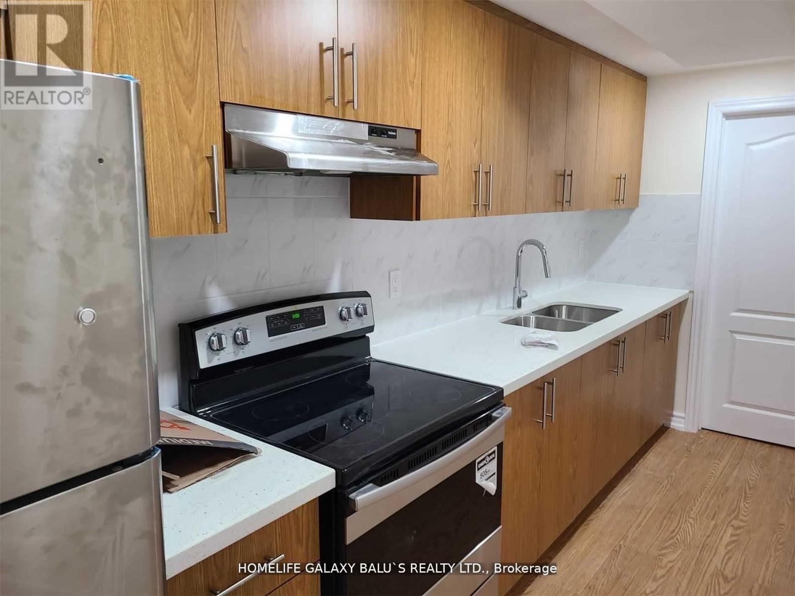 A kitchen with wooden cabinets and a white countertop.