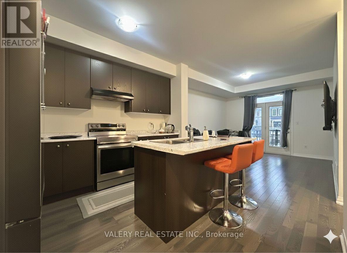 A kitchen with a bar stool and a window.