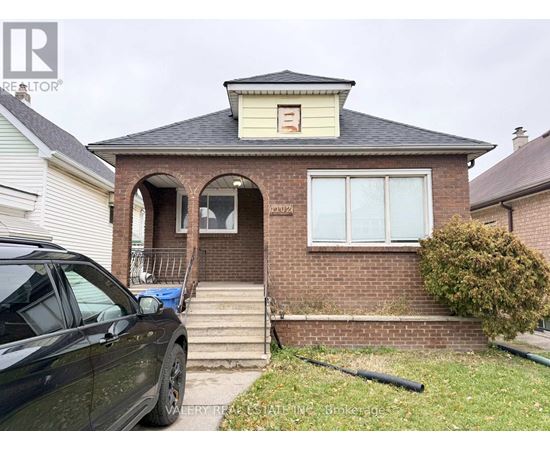 A house with a car parked in front.