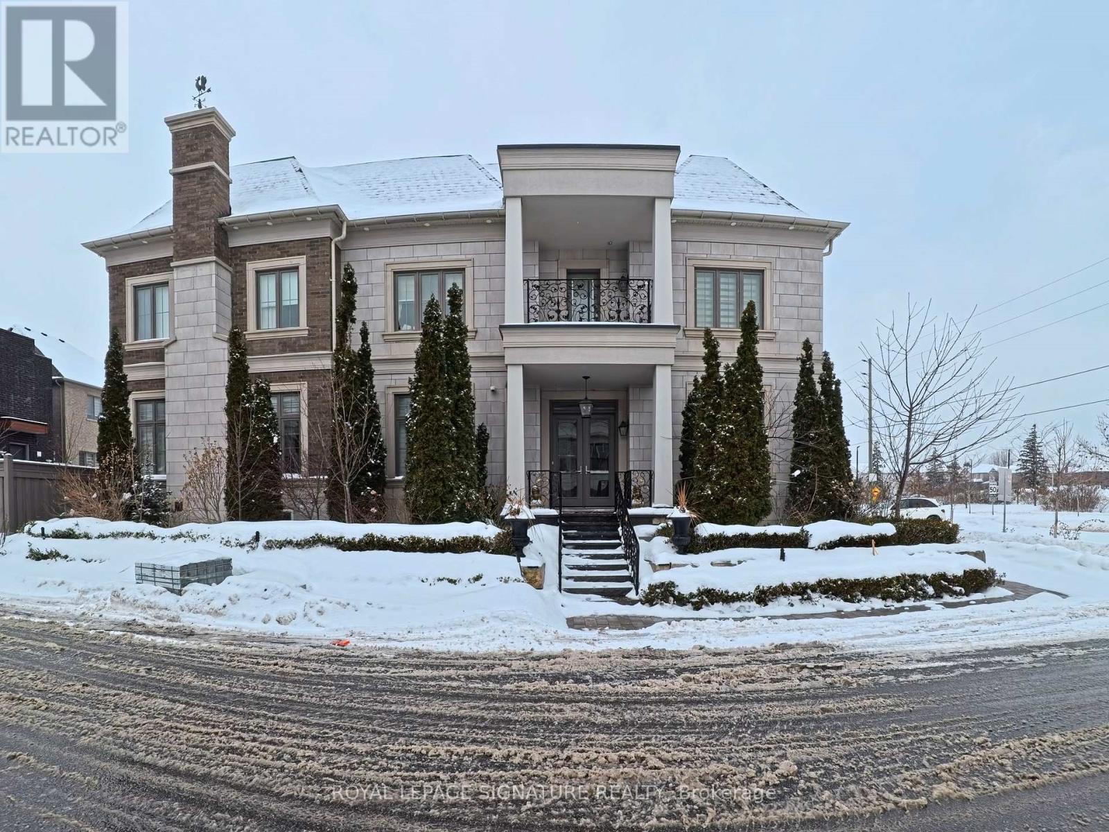 A large house with a snow-covered front yard.