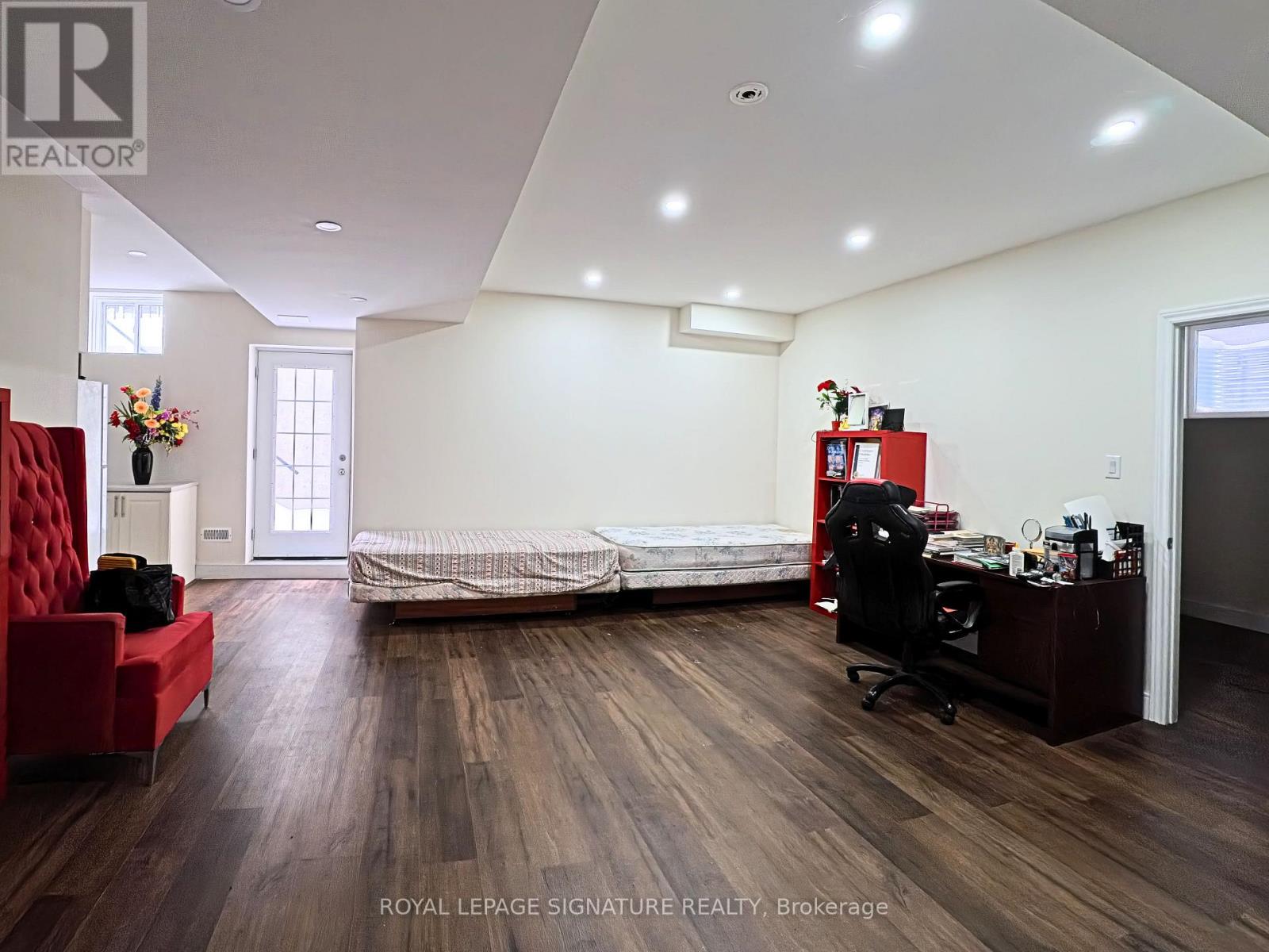 A bedroom with a bed, desk, and chair.