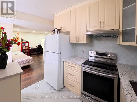 A kitchen with a white refrigerator and stove top oven.