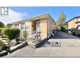 A realtor photo of a house with boarded up windows.