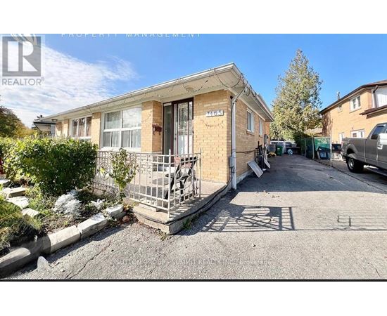 A realtor photo of a house with boarded up windows.