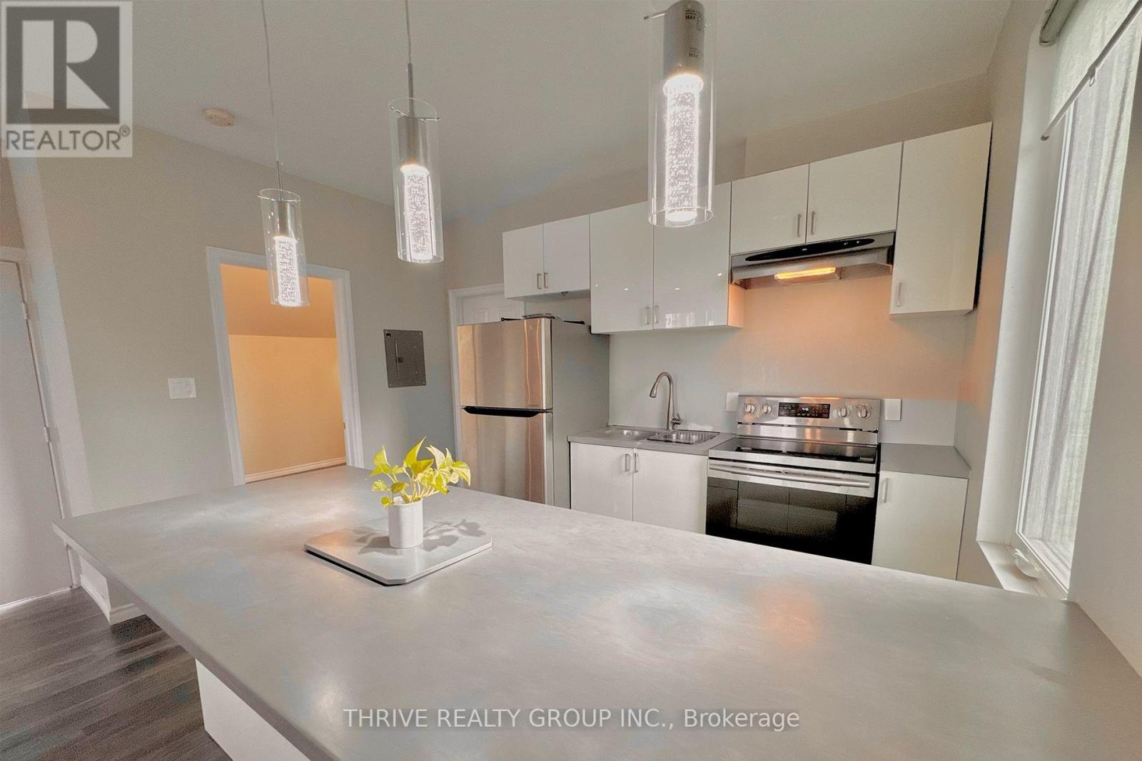 A kitchen with a marble countertop and modern appliances.