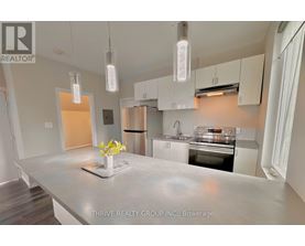 A kitchen with a marble countertop and modern appliances.