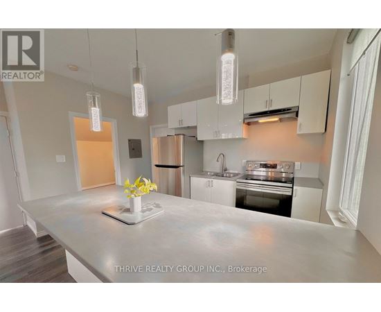 A kitchen with a marble countertop and modern appliances.