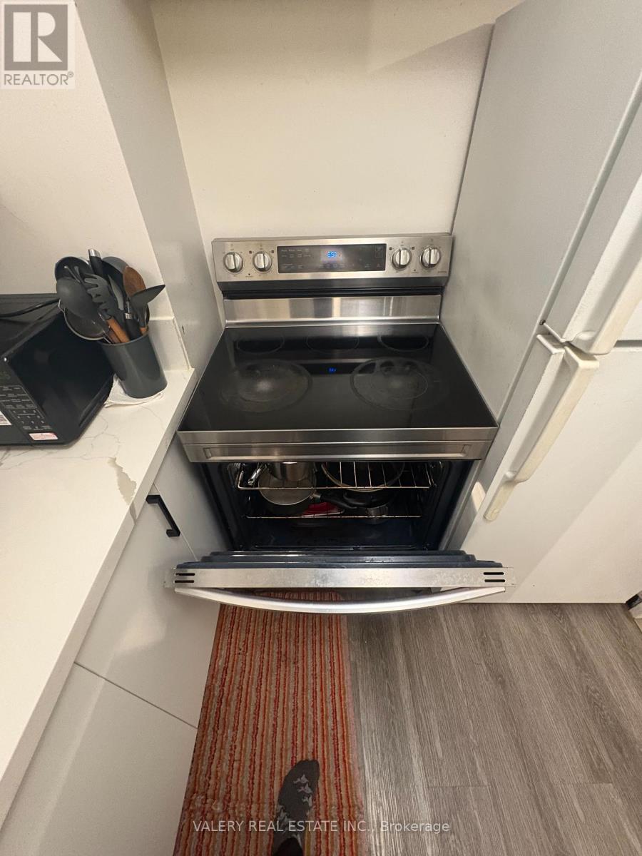A kitchen with a stove top oven and a pot on it.