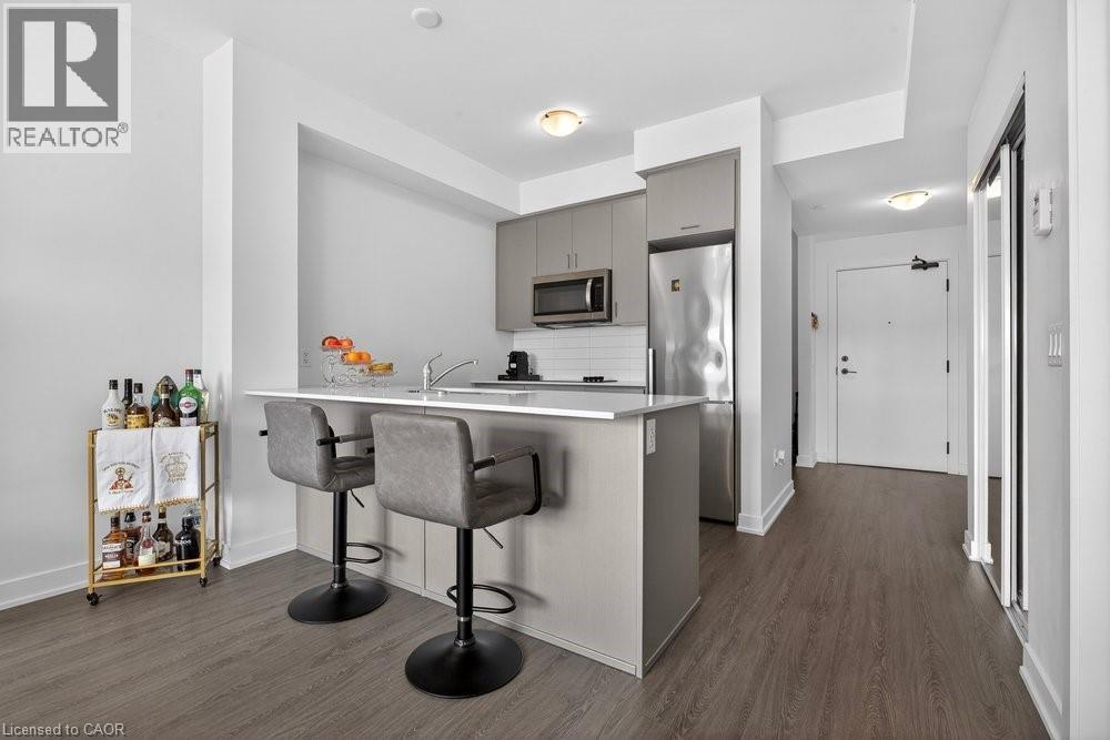 A modern kitchen with a bar area and a wine rack.