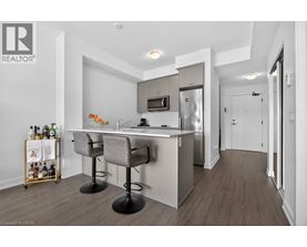 A modern kitchen with a bar area and a wine rack.