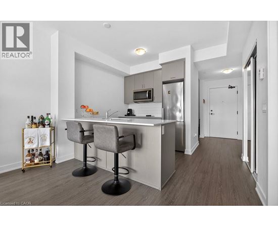 A modern kitchen with a bar area and a wine rack.