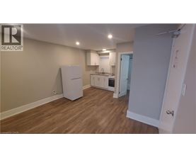 A kitchen area with a refrigerator, sink, and oven.